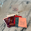 Stack of small cards with text on a marble surface